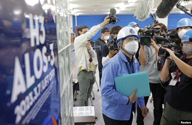 A public relation officer of the Japan Aerospace Exploration Agency (JAXA) explains the launch failure of the H3 rocket at Tanegashima Space Center on the southwestern island of Tanegashima. (Kyodo via REUTERS)