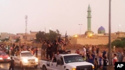 FILE - In this file photo taken Wednesday, June 25, 2014, fighters of the al-Qaida-inspired Islamic State of Iraq and the Levant (ISIL) parade in the northern city of Mosul, Iraq. (AP Photo, File)