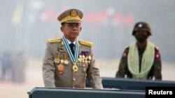 FILE - Myanmar's junta chief Senior General Min Aung Hlaing presides over an army parade on Armed Forces Day in Naypyitaw, March 27, 2021. 