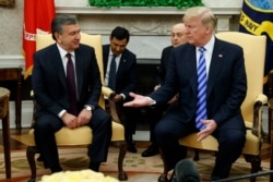 FILE - President Donald Trump meets Uzbek President Shavkat Mirziyoyev in the Oval Office of the White House, May 16, 2018.