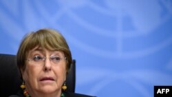 (FILES) In this file photograph taken on December 9, 2020, UN High Commissioner for Human Rights Michelle Bachelet looks on as she attends a press conference in Geneva. - The UN rights chief warned April 13, 2021, of possible crimes against humanity in My