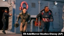 This image released by Disney shows Danny Ramirez, left, and Anthony Mackie in a scene from Marvel Studios' "Captain America: Brave New World." 