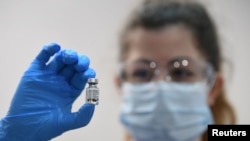 A member of medical staff holds a phial of the Pfizer/BioNTech COVID-19 vaccine jab, at Guy's Hospital, on the first day of the largest immunization programme in the British history, in London, Britain, Dec. 8, 2020.