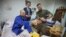 Ukrainian President Volodymyr Zelenskyy, right, and Netherland's caretaker Prime Minister Mark Rutte, center, pose for a photo with a wounded Ukrainian soldier in a hospital in Odesa, Ukraine, on Oct. 13, 2023. (Ukrainian Presidential Press Office via AP)
