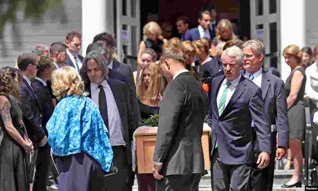 Courtney Kennedy Hill (in blue) and Paul Michael Hill, carrying the casket along with other Kennedy family members, are seen after the funeral mass for their daughter Saoirse Kennedy Hill in Centerville, Massachusetts, Aug. 5, 2019. Saoirse was the 22-year-old granddaughter of the late Robert F. Kennedy.