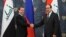 Russian Prime Minister Dmitry Medvedev shake hands with Iraq's Prime Minister Nouri Al-Maliki, right, prior to their meeting in the Gorki residence outside Moscow, October 9, 2012.