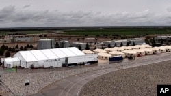 FILE - This undated photo provided by the Administration for Children and Families, a division of the Department of Health and Human Services, shows the shelter used to house unaccompanied migrant children in Tornillo, Texas. 