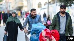 FILE - Residents of the refugee camp of Bureij arrive in Deir al-Balah in the central Gaza Strip following an evacuation order, on December 22, 2023, amid the ongoing conflict between Israel and the Palestinian militant group Hamas.