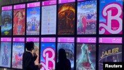 FILE - Among movie promos, "Barbie" is seen at its first screening at VOX Cinemas, in Riyadh, Saudi Arabia, Aug. 10, 2023.