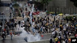 Riot police fire tear gas to protesters outside the Legislative Council in Hong Kong, June 12, 2019. 