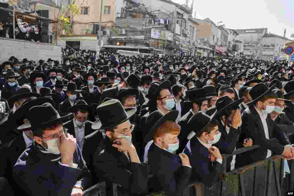 Despite the coronavirus pandemic, thousands of Ultra-orthodox Jewish men attend the funeral of Rabbi Aharon David Hadash, the spiritual leader of the Mir Yeshiva, in Jerusalem&#39;s Ultra-Orthodox neighbourhood of Beit Yisrael.