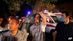 A man whose relative is on staff at Sina Athar Clinic weeps after its explosion, outside the clinic in Tehran, Iran, early Wednesday, July 1, 2020. Iranian state TV says a gas leak explosion in a clinic in northern Tehran has killed multiple people.