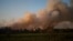 FILE - A fire rages over the Chateau des Bertrands vineyard in Le Cannet-des-Maures, Aug.17, 2021, in southern France.