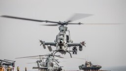 FILE - An AH-1Z Viper from the 11th Marine Expeditionary Unit prepares for takeoff aboard the amphibious assault ship USS Boxer as it transits the Strait of Hormuz, off Oman, in this U.S. Navy photo.
