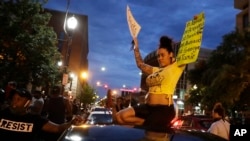 Demonstrators protest over the deaths of George Floyd and Breonna Taylor, June 1, 2020, in Louisville, Ky. Breonna Taylor, a black woman, was fatally shot by police in her home in March.