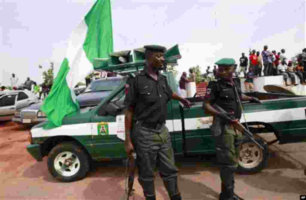 Police officers attend an event to celebrate the life of late author Chinua Achebe in Awka, Nigeria, Wednesday, May 22, 2013.