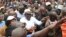 Kenya's opposition leader, Raila Odinga, centre, joins his supporters in the Mathare area where four people were killed overnight, in Nairobi, Nov. 19, 2017. 