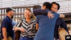 Ammala Mingsouan embraces family outside the Immigration and Customs Enforcement and the Atlanta Immigration Court after being released from ICE custody, in Atlanta, June 12, 2019. Mingsouan's mother, right, said she had not seen him for 24 years.