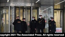 Police officers stand outside the main entrance of the St Bartholomew’s Hospital where Britain's Prince Philip is being treated, in London, March 4, 2021. 