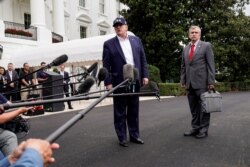 FILE - U.S. President Donald Trump speaks to the media about Hurricane Dorian with Rear Admiral Peter J. Brown, Assistant Commandant for Response Policy, as he returns from Camp David to the White House, Sept. 1, 2019.