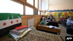 FILE - Syrian schoolchildren attend class at a school in the capital Damascus' Dweilaa neighborhood on Dec. 15, 2024. 