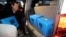 A prosecution investigation officer moves boxes carrying evidence seized at a branch office of National Pension Service in Jeonju, South Korea, Nov. 23, 2016.