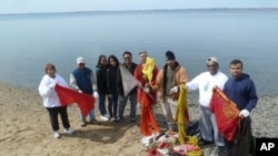 The cleanup volunteers accumulate a pile of prayer flags, saris and other trash left over from sacred Hindu ceremonies.