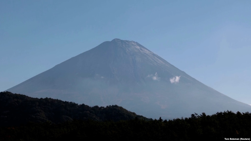 Peak of Mount Fuji showing snow as seen from Fujikawaguchiko, Yamanashi Prefecture, Japan. November 7, 2024. (Tom Bateman/REUTERS)