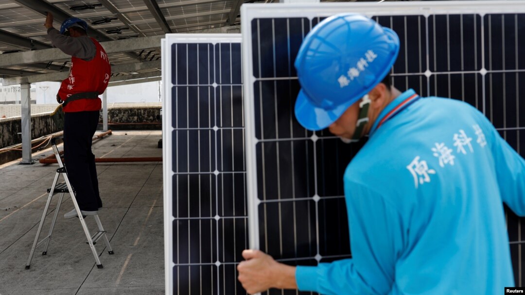 A prisoner places solar panels on the roof of Pingtung prison in Pingtung, Taiwan, Feb. 15, 2017. 