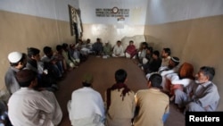 FILE - HIV patients take part in an awareness session at Pakistan Society, a nongovernmental organization drop-in center, in Karachi, Nov. 30, 2013. 