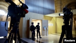 French gendarmes guard a courtroom on the first day of a trial of eight people accused of involvement in the 2020 beheading in a Paris suburb of French history teacher Samuel Paty, in Paris, France, Nov. 4, 2024. 