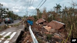 Houses destroyed by Typhoon Goni lie along the side of road in Albay province, central Philippines, on Nov. 3, 2020.