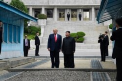 President Donald Trump and North Korean leader Kim Jong Un stand on the North Korean side in the Demilitarized Zone, Sunday, June 30, 2019 at Panmunjom.