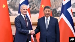 In this photo released by Xinhua News Agency, Norway's Prime Minister Jonas Gahr Store, left, meets with Chinese President Xi Jinping at the Diaoyutai State Guesthouse in Beijing, Sept. 9 2024.