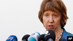 European foreign policy chief Catherine Ashton talks with journalists as she arrives for a Informal Meeting of EU Ministers for Foreign Affairs in Vilnius, Lithuania, Sept. 6, 2013. 