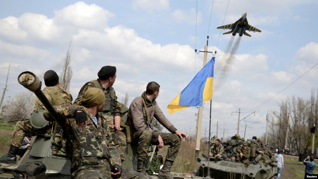 Binh sĩ Ukraine và máy bay chiến đấu bay ngang thị trấn Kramatorsk ở miền đông Ukraine, ngày 16/4/2014. 