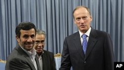 Iranian President Mahmoud Ahmadinejad, left, welcomes Russia's Security Council Secretary Nikolai Patrushev for their meeting at the presidency office, in Tehran, Iran, August 16, 2011