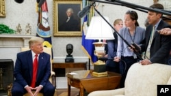 FILE - President Donald Trump talks to reporters in the Oval Office of the White House, in Washington, July 9, 2019.