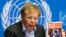 FILE - World Health Organization Assistant Director General Bruce Aylward holds a report during a news conference on Ebola at the United Nations in Geneva, Sept. 16, 2014.