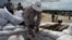 FILE - In this July 31, 2013 photo, a Vietnamese deminer hands unexploded ordinance to a colleague ahead of a controlled detonation in Vinh Thai, Vietnam.