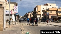 Locals examine a street recently hit by a bomb in Tripoli, Libya, March 27, 2020. (Courtesy of resident Mohammed Kikly)