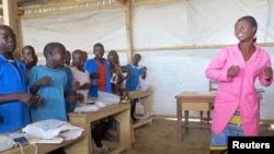 FILE - Teneng Sidonie Weteck sings and dances in class at a school for displaced Nigerian children at the Minawao camp, northern Cameroon, February 18, 2015.