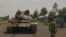 A Congolese government tank prepares to deploy for fighting against M23 rebels, at an operating base in Kanyaruchinya, north of Goma, eastern Democratic Republic of Congo, Aug. 23, 2013. 