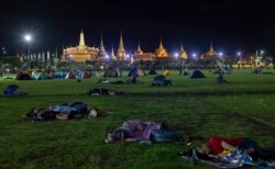 FILE - Pro-democracy activists sleep in the historic field of Sanam Luang they occupied for an overnight protest rally in Bangkok, Thailand, Sept. 20, 2020.
