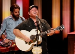 Luke Combs performs at "Luke Combs Joins the Grand Ole Opry Family," at the Grand Ole Opry, July 16, 2019, in Nashville, Tenn.