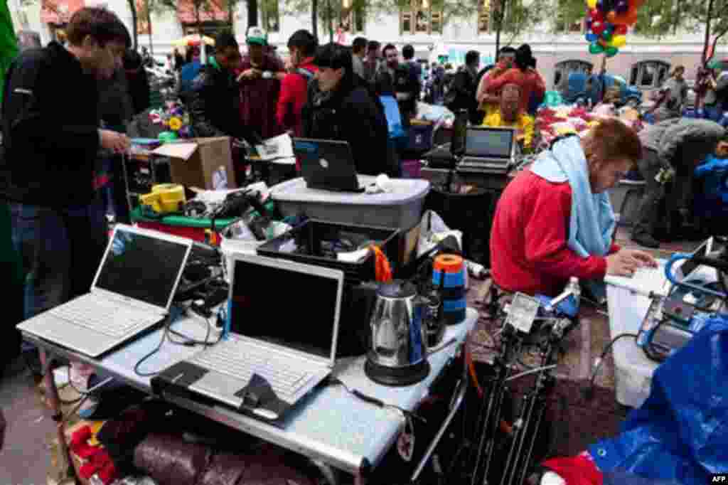 Protestors at Occupy Wall Street's media area coordinate news updates on laptop computers powered by a portable gas-powered generator in Manhattan's financial district's Zuccotti park, Sunday, Oct. 2, 2011, in New York. The Occupy Wall Street demonstratio