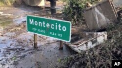 U.S. 101 highway remains underwater as cleanup crews work to clear the roads throughout Montecito, Calif., Jan. 15, 2018, following the deadly mudflow and flooding Jan. 9. California officials weren't sure Monday when the key coastal highway might reopen.