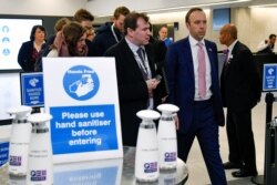 Health Secretary Matt Hancock walks past a hand washing station as he leaves after talking about coronavirus at the annual conference of the British Chambers of Commerce in London, March 5, 2020.