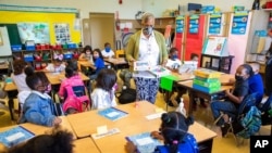 Joy Harrison instructs second-graders at Munck Elementary School, Aug. 11, 2021, in Oakland, California. The state will require its 320,000 teachers and school employees to be vaccinated against the novel coronavirus or submit to weekly COVID-19 testing.