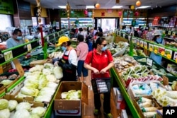 FILE - Customers shop for produce in the Chinatown neighborhood of Philadelphia, Pennsylvania, on July 22, 2022. A new poll shows that half of Asian Americans, Native Hawaiians and Pacific Islanders under 34 believe the U.S. is “too supportive” of Israel.